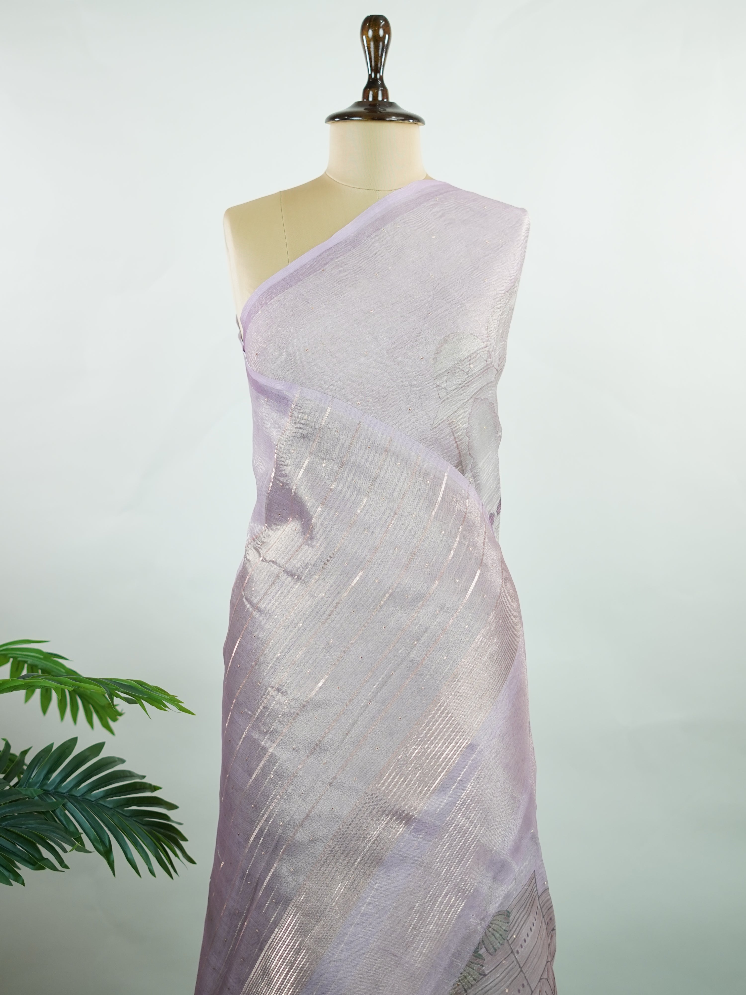tissue A delicate Banaras Tissue saree woven in the heritage looms of Varanasi, this piece captures the timeless shimmer of fine zari work on a lightweight, translucent base. The luminous fabric drapes effortlessly and catches the light beautifully, making it an ideal choice for festive gatherings, pujas, and celebrations. Its airy texture keeps you comfortable while the subtle zari detailing adds a touch of understated elegance. tissue - Semi Silk Saree - Manoranjitham Weaves - Handloom Store