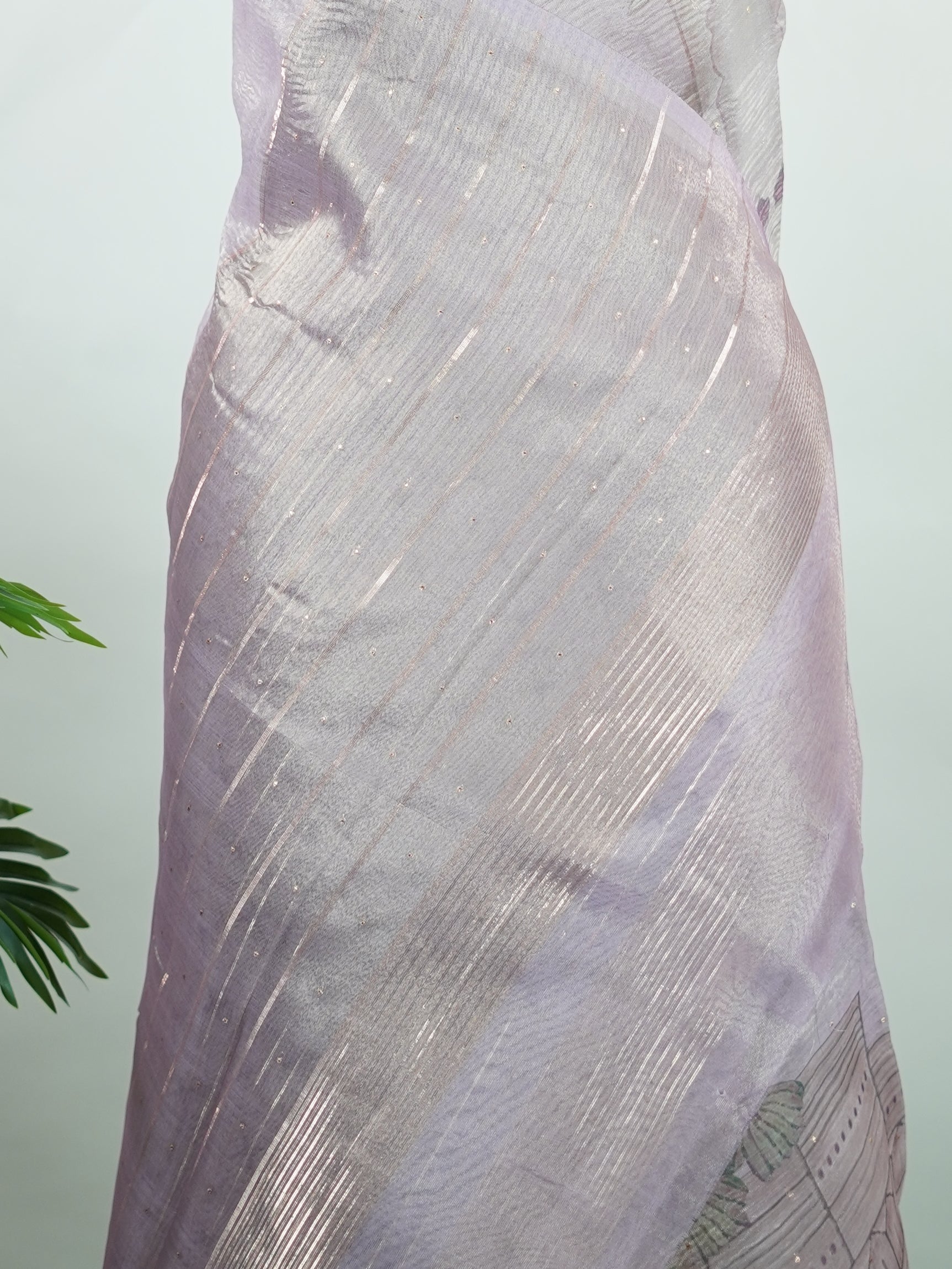 tissue A delicate Banaras Tissue saree woven in the heritage looms of Varanasi, this piece captures the timeless shimmer of fine zari work on a lightweight, translucent base. The luminous fabric drapes effortlessly and catches the light beautifully, making it an ideal choice for festive gatherings, pujas, and celebrations. Its airy texture keeps you comfortable while the subtle zari detailing adds a touch of understated elegance. tissue - Semi Silk Saree - Manoranjitham Weaves - Handloom Store
