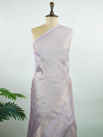 tissue A delicate Banaras Tissue saree woven in the heritage looms of Varanasi, this piece captures the timeless shimmer of fine zari work on a lightweight, translucent base. The luminous fabric drapes effortlessly and catches the light beautifully, making it an ideal choice for festive gatherings, pujas, and celebrations. Its airy texture keeps you comfortable while the subtle zari detailing adds a touch of understated elegance. tissue - Semi Silk Saree - Manoranjitham Weaves - Handloom Store