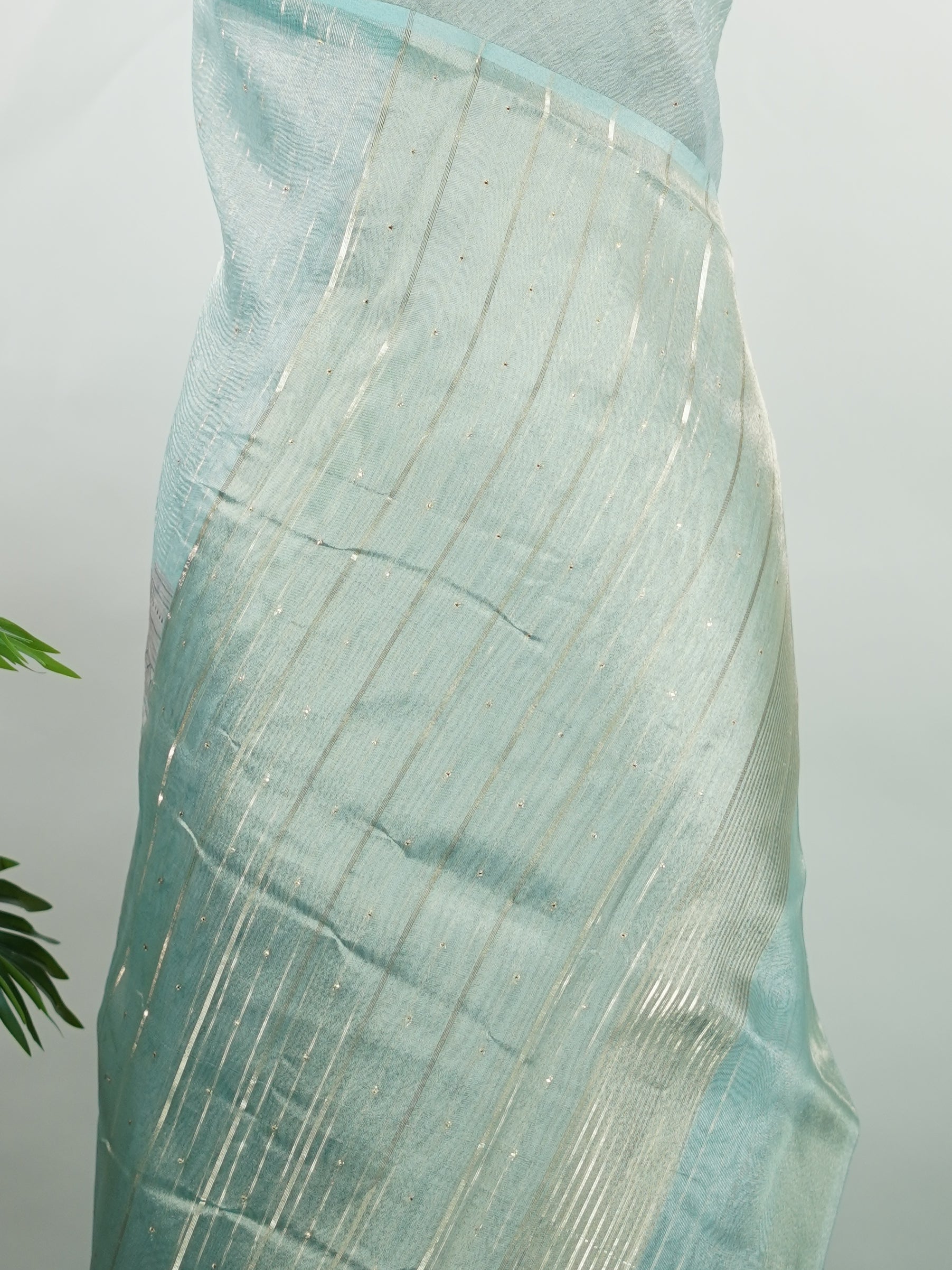 tissue A delicate Banaras Tissue saree woven in the heritage looms of Varanasi, this piece captures the timeless shimmer of fine zari work on a lightweight, translucent base. The luminous fabric drapes effortlessly and catches the light beautifully, making it an ideal choice for festive gatherings, pujas, and celebrations. Its airy texture keeps you comfortable while the subtle zari detailing adds a touch of understated elegance. tissue - Semi Silk Saree - Manoranjitham Weaves - Handloom Store