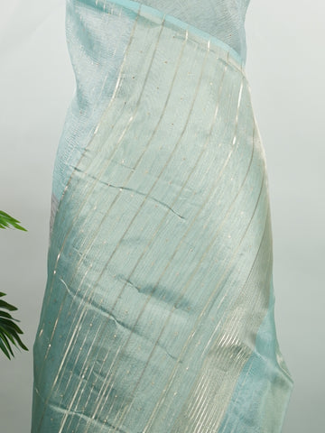 tissue A delicate Banaras Tissue saree woven in the heritage looms of Varanasi, this piece captures the timeless shimmer of fine zari work on a lightweight, translucent base. The luminous fabric drapes effortlessly and catches the light beautifully, making it an ideal choice for festive gatherings, pujas, and celebrations. Its airy texture keeps you comfortable while the subtle zari detailing adds a touch of understated elegance. tissue - Semi Silk Saree - Manoranjitham Weaves - Handloom Store