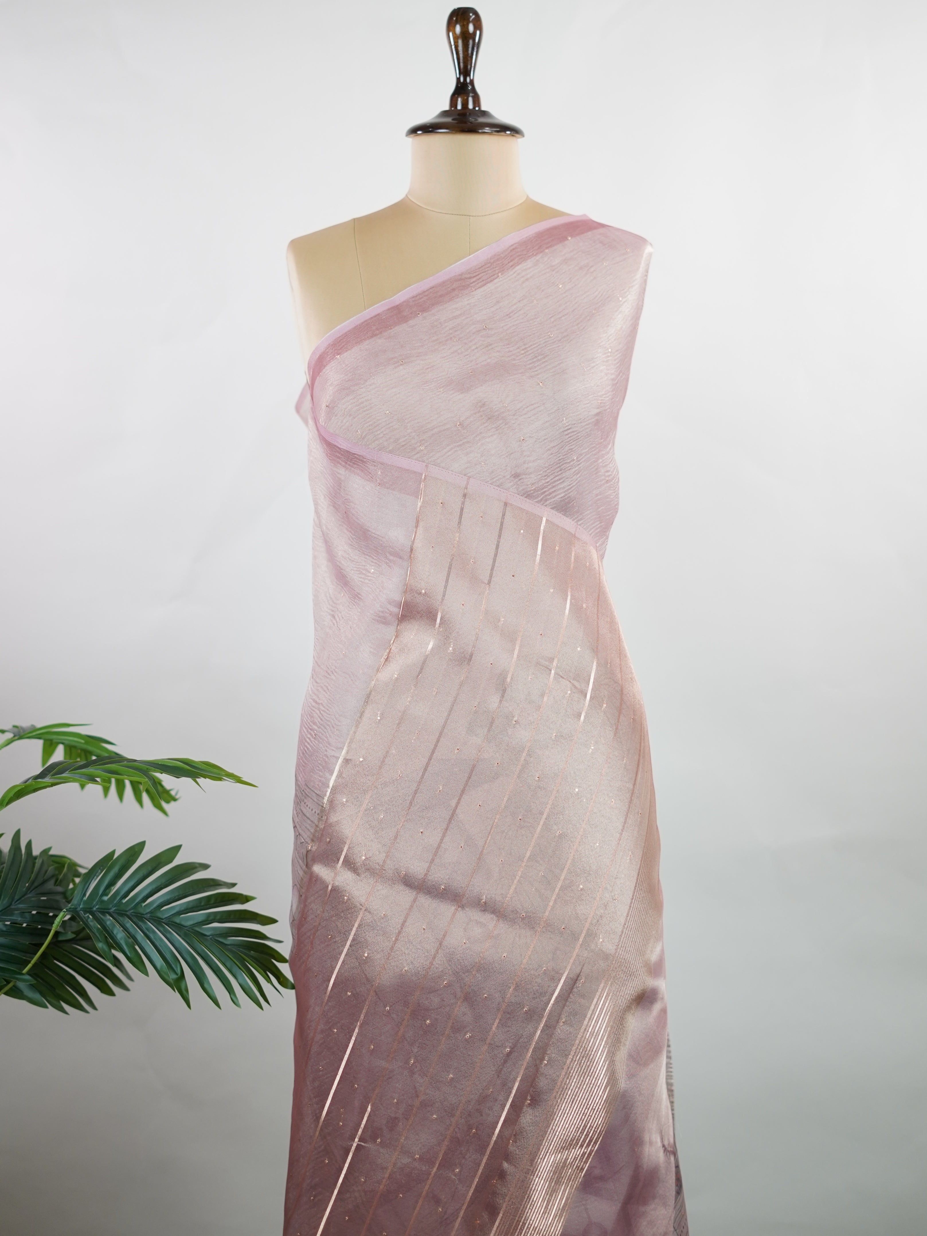 tissue A delicate Banaras Tissue saree woven in the heritage looms of Varanasi, this piece captures the timeless shimmer of fine zari work on a lightweight, translucent base. The luminous fabric drapes effortlessly and catches the light beautifully, making it an ideal choice for festive gatherings, pujas, and celebrations. Its airy texture keeps you comfortable while the subtle zari detailing adds a touch of understated elegance. tissue - Semi Silk Saree - Manoranjitham Weaves - Handloom Store