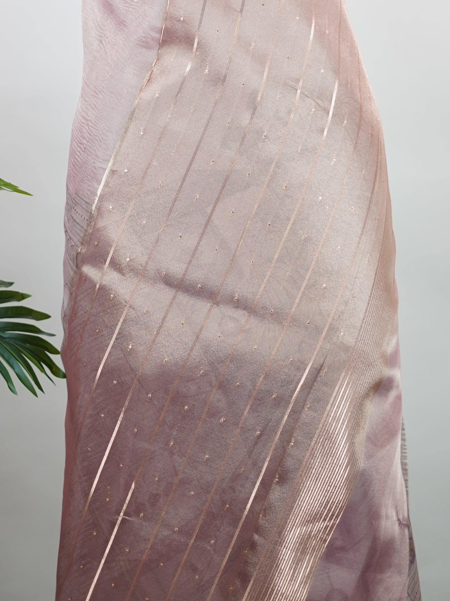 tissue A delicate Banaras Tissue saree woven in the heritage looms of Varanasi, this piece captures the timeless shimmer of fine zari work on a lightweight, translucent base. The luminous fabric drapes effortlessly and catches the light beautifully, making it an ideal choice for festive gatherings, pujas, and celebrations. Its airy texture keeps you comfortable while the subtle zari detailing adds a touch of understated elegance. tissue - Semi Silk Saree - Manoranjitham Weaves - Handloom Store
