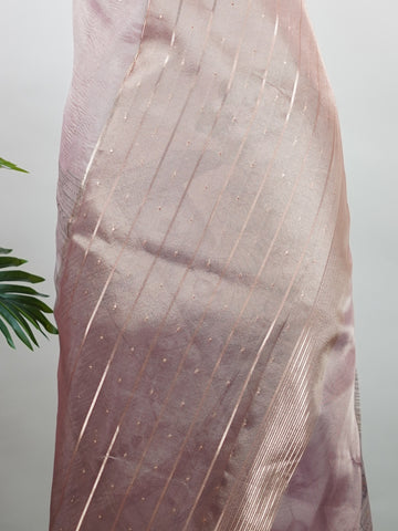tissue A delicate Banaras Tissue saree woven in the heritage looms of Varanasi, this piece captures the timeless shimmer of fine zari work on a lightweight, translucent base. The luminous fabric drapes effortlessly and catches the light beautifully, making it an ideal choice for festive gatherings, pujas, and celebrations. Its airy texture keeps you comfortable while the subtle zari detailing adds a touch of understated elegance. tissue - Semi Silk Saree - Manoranjitham Weaves - Handloom Store