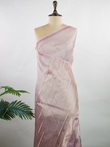 tissue A delicate Banaras Tissue saree woven in the heritage looms of Varanasi, this piece captures the timeless shimmer of fine zari work on a lightweight, translucent base. The luminous fabric drapes effortlessly and catches the light beautifully, making it an ideal choice for festive gatherings, pujas, and celebrations. Its airy texture keeps you comfortable while the subtle zari detailing adds a touch of understated elegance. tissue - Semi Silk Saree - Manoranjitham Weaves - Handloom Store