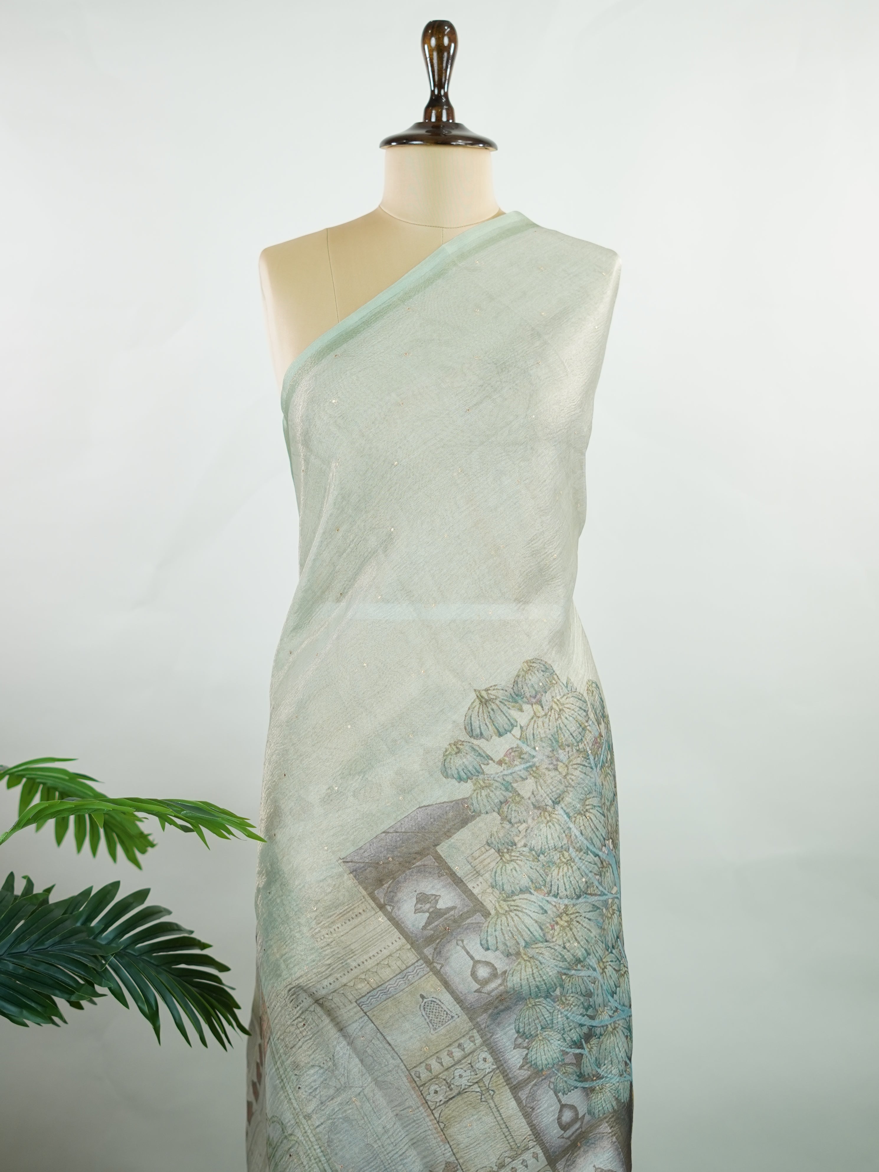 tissue A delicate Banaras Tissue saree woven in the heritage looms of Varanasi, this piece captures the timeless shimmer of fine zari work on a lightweight, translucent base. The luminous fabric drapes effortlessly and catches the light beautifully, making it an ideal choice for festive gatherings, pujas, and celebrations. Its airy texture keeps you comfortable while the subtle zari detailing adds a touch of understated elegance. tissue - Semi Silk Saree - Manoranjitham Weaves - Handloom Store