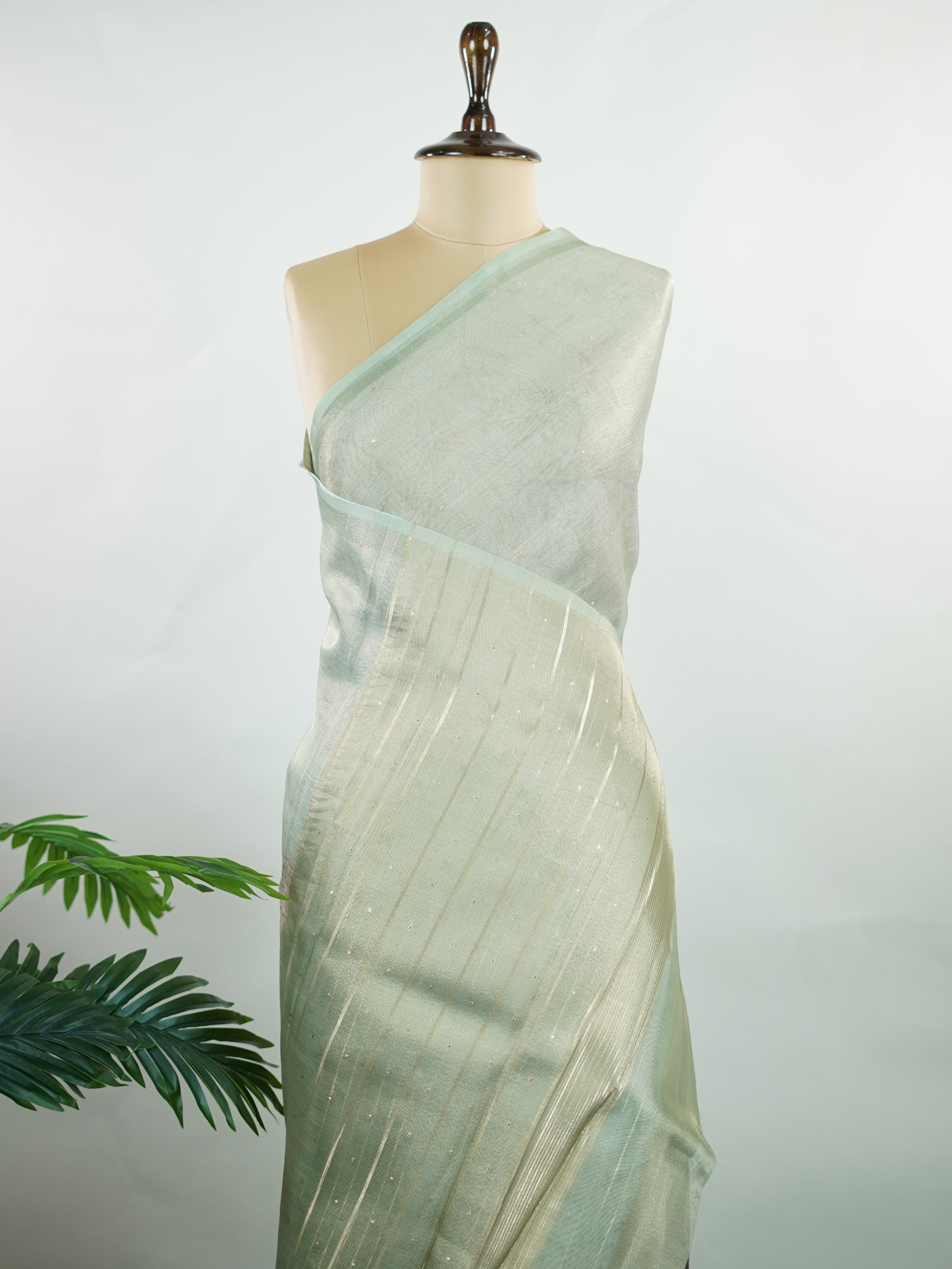 tissue A delicate Banaras Tissue saree woven in the heritage looms of Varanasi, this piece captures the timeless shimmer of fine zari work on a lightweight, translucent base. The luminous fabric drapes effortlessly and catches the light beautifully, making it an ideal choice for festive gatherings, pujas, and celebrations. Its airy texture keeps you comfortable while the subtle zari detailing adds a touch of understated elegance. tissue - Semi Silk Saree - Manoranjitham Weaves - Handloom Store