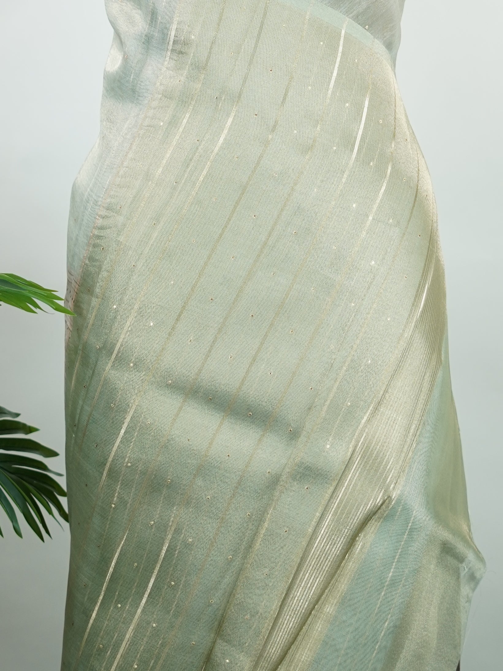 tissue A delicate Banaras Tissue saree woven in the heritage looms of Varanasi, this piece captures the timeless shimmer of fine zari work on a lightweight, translucent base. The luminous fabric drapes effortlessly and catches the light beautifully, making it an ideal choice for festive gatherings, pujas, and celebrations. Its airy texture keeps you comfortable while the subtle zari detailing adds a touch of understated elegance. tissue - Semi Silk Saree - Manoranjitham Weaves - Handloom Store