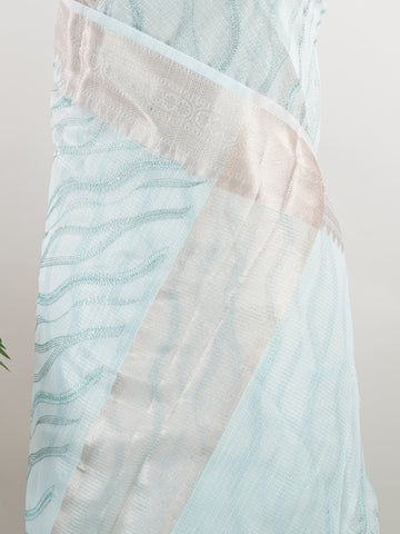 Kora This exquisite Light Blue Kora Tissue saree dazzles with delicate gold floral zari work, weaving elegance into every thread. Crafted on a powerloom in Varanasi, its lightweight texture shimmers beautifully, perfect for festive occasions or celebrations. The fine zari detailing adds a regal touch, blending tradition with contemporary charm. Wrap yourself in this graceful masterpiece and shine with timeless beauty. Nagagandhari - Manoranjitham Weaves - Handloom Store