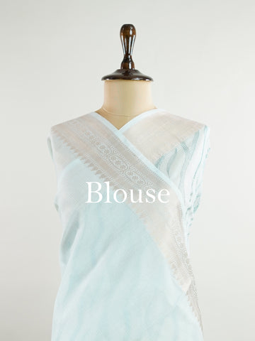 Kora This exquisite Light Blue Kora Tissue saree dazzles with delicate gold floral zari work, weaving elegance into every thread. Crafted on a powerloom in Varanasi, its lightweight texture shimmers beautifully, perfect for festive occasions or celebrations. The fine zari detailing adds a regal touch, blending tradition with contemporary charm. Wrap yourself in this graceful masterpiece and shine with timeless beauty. Nagagandhari - Manoranjitham Weaves - Handloom Store