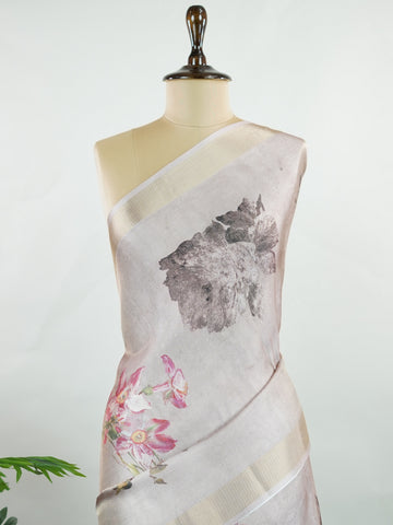 Kora This sheer Kora saree, crafted on powerlooms in Varanasi, is a celebration of lightness and elegance. Its translucent base is adorned with delicate gold zari work, weaving graceful patterns that shimmer with every movement. Ideal for summer festivities, daytime celebrations, and casual occasions, this saree offers a breezy, effortless drape with a refined traditional touch. Kora - Handloom Pure Silk Saree - Manoranjitham Weaves - Handloom Store