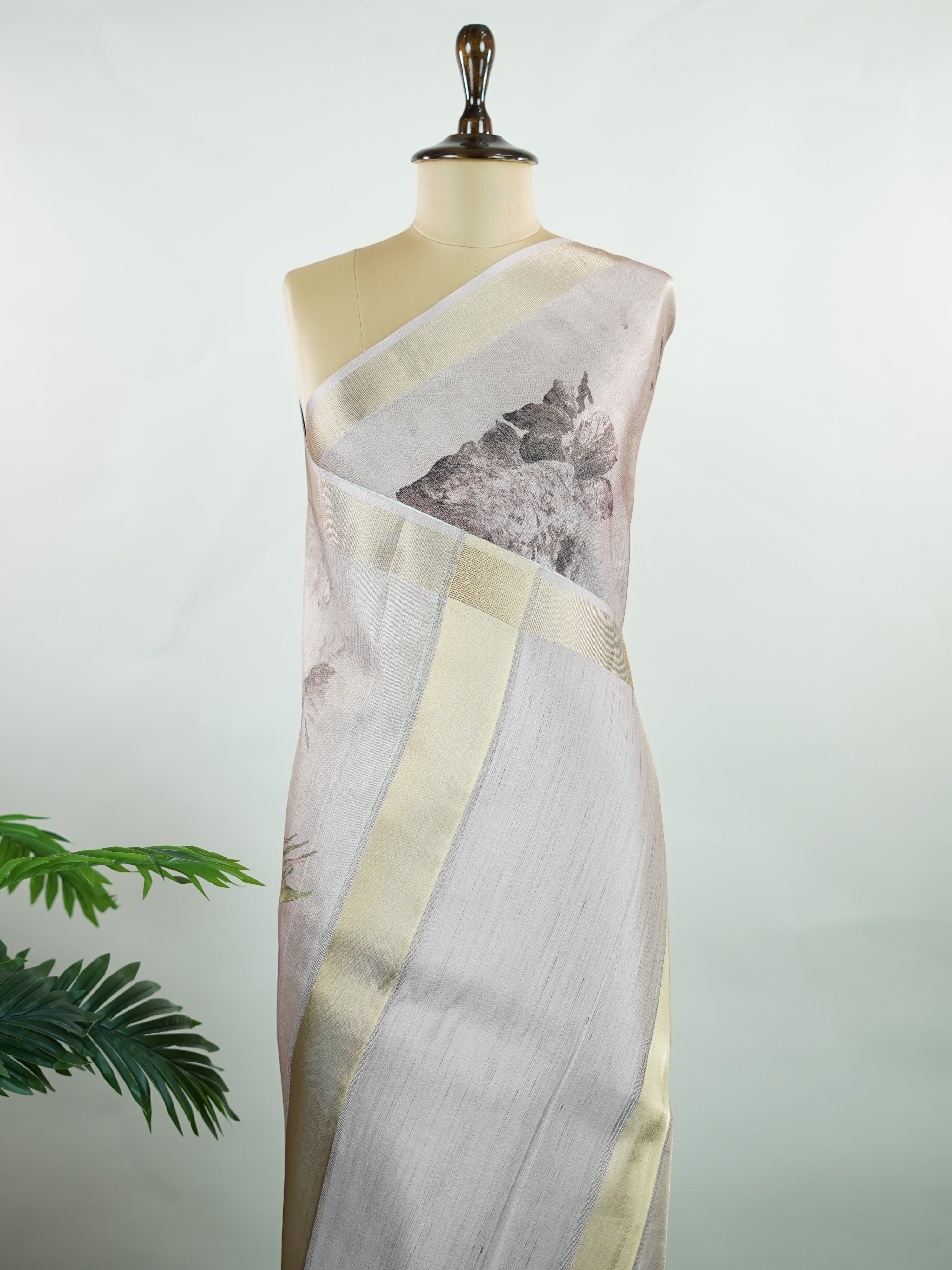 Kora This sheer Kora saree, crafted on powerlooms in Varanasi, is a celebration of lightness and elegance. Its translucent base is adorned with delicate gold zari work, weaving graceful patterns that shimmer with every movement. Ideal for summer festivities, daytime celebrations, and casual occasions, this saree offers a breezy, effortless drape with a refined traditional touch. Kora - Handloom Pure Silk Saree - Manoranjitham Weaves - Handloom Store