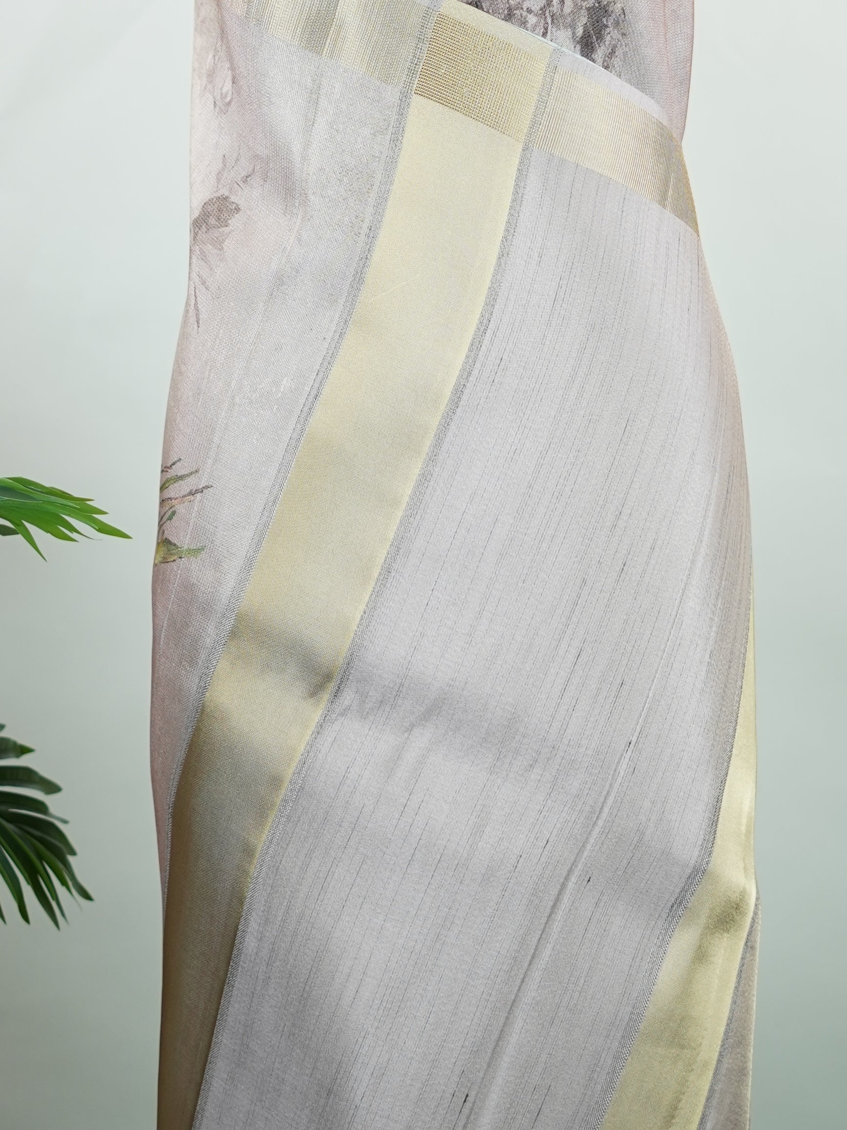 Kora This sheer Kora saree, crafted on powerlooms in Varanasi, is a celebration of lightness and elegance. Its translucent base is adorned with delicate gold zari work, weaving graceful patterns that shimmer with every movement. Ideal for summer festivities, daytime celebrations, and casual occasions, this saree offers a breezy, effortless drape with a refined traditional touch. Kora - Handloom Pure Silk Saree - Manoranjitham Weaves - Handloom Store