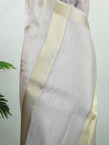 Kora This sheer Kora saree, crafted on powerlooms in Varanasi, is a celebration of lightness and elegance. Its translucent base is adorned with delicate gold zari work, weaving graceful patterns that shimmer with every movement. Ideal for summer festivities, daytime celebrations, and casual occasions, this saree offers a breezy, effortless drape with a refined traditional touch. Kora - Handloom Pure Silk Saree - Manoranjitham Weaves - Handloom Store