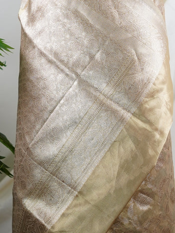 Katan A Tissue saree is the perfect blend of delicate silk and shimmering zari, woven to create an ethereal, translucent fabric that sparkles with every movement. Lightweight and luxurious, it’s ideal for grand occasions and celebrations where elegance is key. Draped in a Tissue saree, you embody timeless glamour with a modern twist. Avyaktha - Banarasi Tissue Kora Saree - Manoranjitham Weaves - Handloom Store
