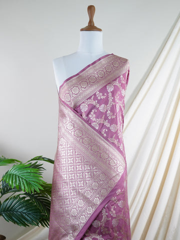 Katan Ponnarajula embodies the golden hues of blooms, a full jaal Katan silk saree that gracefully envelops you in elegance. This exquisite piece showcases a stunning interplay of colors skillfully woven into the fabric, creating a radiant visual impact. Adorned with intricate pure zari detailing and refined handwork, it is ideal for festive occasions and special celebrations. Embrace the rich heritage of Varanasi craftsmanship with Ponnarajula, a timeless symbol of beauty. Ponnarajula - Banarasi Katan Silk