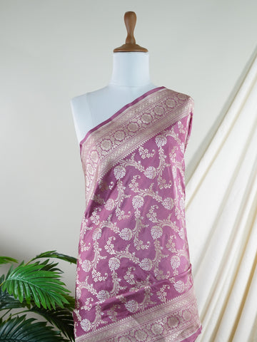 Katan Ponnarajula embodies the golden hues of blooms, a full jaal Katan silk saree that gracefully envelops you in elegance. This exquisite piece showcases a stunning interplay of colors skillfully woven into the fabric, creating a radiant visual impact. Adorned with intricate pure zari detailing and refined handwork, it is ideal for festive occasions and special celebrations. Embrace the rich heritage of Varanasi craftsmanship with Ponnarajula, a timeless symbol of beauty. Ponnarajula - Banarasi Katan Silk