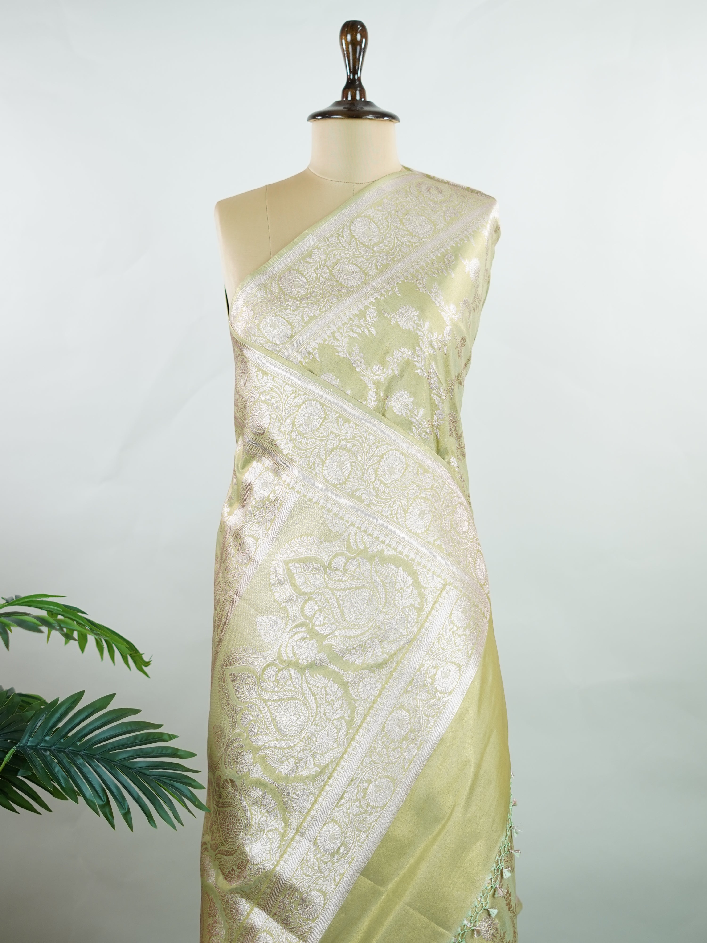 Semi Silk In a lush green hue with fine gold zari jaal, this semi tissue saree from Varanasi shimmers with understated grandeur. The delicate weave and sheer finish create a light yet festive drape—perfect for elegant rituals and serene celebrations.br
#SemiTissueSaree #FineZariWeave #GreenAndGold #VaranasiElegance #HandloomHeritage #Manoranjitham #ManoranjithamStyle Nayana - Semi Silk Saree | Full Jaal Zari - Manoranjitham Weaves - Handloom Store