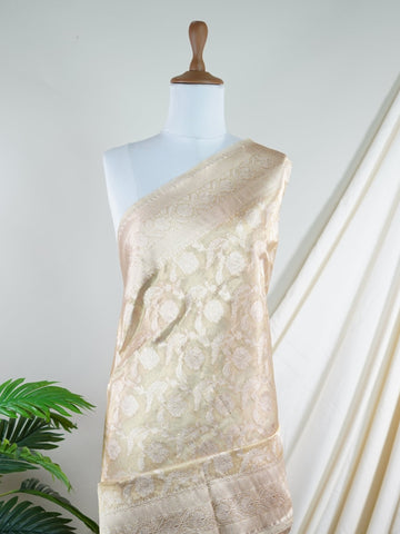 Katan A Tissue saree is the perfect blend of delicate silk and shimmering zari, woven to create an ethereal, translucent fabric that sparkles with every movement. Lightweight and luxurious, it’s ideal for grand occasions and celebrations where elegance is key. Draped in a Tissue saree, you embody timeless glamour with a modern twist. Avyaktha - Banarasi Tissue Kora Saree - Manoranjitham Weaves - Handloom Store