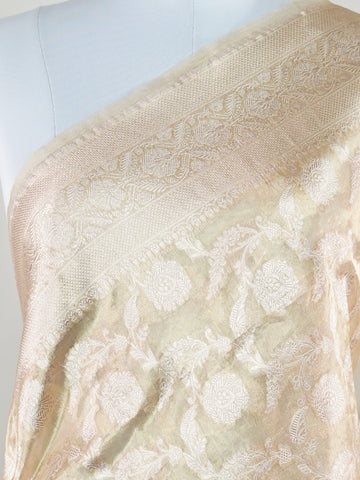 Katan A Tissue saree is the perfect blend of delicate silk and shimmering zari, woven to create an ethereal, translucent fabric that sparkles with every movement. Lightweight and luxurious, it’s ideal for grand occasions and celebrations where elegance is key. Draped in a Tissue saree, you embody timeless glamour with a modern twist. Avyaktha - Banarasi Tissue Kora Saree - Manoranjitham Weaves - Handloom Store