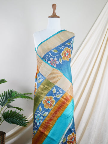 Tussars A Tussar saree with digital print and intricate Aari Peeta embroidery, combining modern design with delicate handcraft. Bageshree - Manoranjitham Weaves - Handloom Store