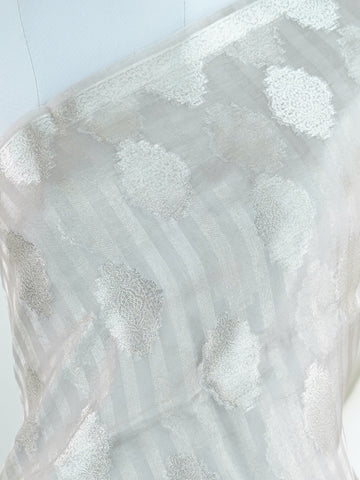 tissue Woven with the finest silk, this 100% Pure Silk  saree in Mint Green blends tradition and grace. Its Gold and Silver Zari Buttas detailing adds a touch of bridal opulence. Bhinnashadja - Mint Green Banarasi Tissue Kora Saree | Zari Buttas - Manoranjitham Weaves - Handloom Store