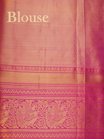 Kanchipuram Silk A sublime olive green Kanchipuram silk saree, gracefully adorned with gold and silver zari buttas, reflecting timeless artistry. The vibrant pink border lends a striking contrast, perfect for festive occasions and weddings. Woven from 100% pure silk, this saree radiates heritage and elegance in every thread.Its luxurious texture and intricate zari work make it a cherished piece for your trousseau or special celebrations.          #ManoranjithamSilks #KanjivaramHandloom #PureSilkSaree #Brida