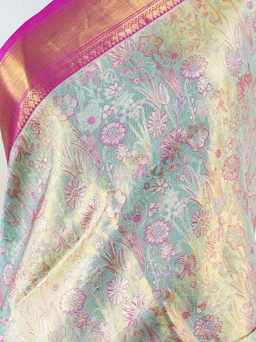 Kanchipuram Silk A sublime olive green Kanchipuram silk saree, gracefully adorned with gold and silver zari buttas, reflecting timeless artistry. The vibrant pink border lends a striking contrast, perfect for festive occasions and weddings. Woven from 100% pure silk, this saree radiates heritage and elegance in every thread.Its luxurious texture and intricate zari work make it a cherished piece for your trousseau or special celebrations.          #ManoranjithamSilks #KanjivaramHandloom #PureSilkSaree #Brida