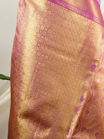 Kanchipuram Silk A sublime olive green Kanchipuram silk saree, gracefully adorned with gold and silver zari buttas, reflecting timeless artistry. The vibrant pink border lends a striking contrast, perfect for festive occasions and weddings. Woven from 100% pure silk, this saree radiates heritage and elegance in every thread.Its luxurious texture and intricate zari work make it a cherished piece for your trousseau or special celebrations.          #ManoranjithamSilks #KanjivaramHandloom #PureSilkSaree #Brida
