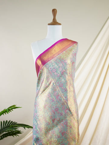 Kanchipuram Silk A sublime olive green Kanchipuram silk saree, gracefully adorned with gold and silver zari buttas, reflecting timeless artistry. The vibrant pink border lends a striking contrast, perfect for festive occasions and weddings. Woven from 100% pure silk, this saree radiates heritage and elegance in every thread.Its luxurious texture and intricate zari work make it a cherished piece for your trousseau or special celebrations.          #ManoranjithamSilks #KanjivaramHandloom #PureSilkSaree #Brida