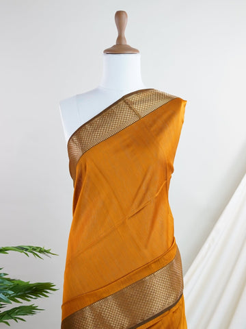 Maheshwari Handwoven by skilled artisans of Surat, this Semi Silk saree in Golden Brown blends traditional elegance with intricate nan zari work. A truly stunning drape for special occasions. The interplay of colors and craftsmanship makes it a treasured piece for every saree connoisseur. Darbari - Golden Brown Semi Silk Saree - Manoranjitham Weaves - Handloom Store