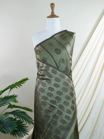 Chiniya Silk A masterpiece in Kota, this Brown saree adorned with Buttis patterns exudes regal charm. Perfect for the modern bride who cherishes tradition. Divya - Manoranjitham Weaves - Handloom Store