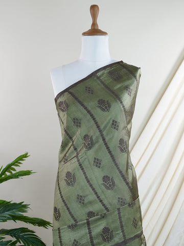 Chiniya Silk A masterpiece in Kota, this Brown saree adorned with Buttis patterns exudes regal charm. Perfect for the modern bride who cherishes tradition. Divya - Manoranjitham Weaves - Handloom Store