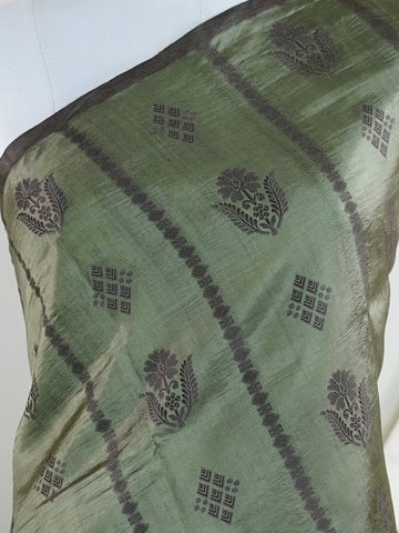 Chiniya Silk A masterpiece in Kota, this Brown saree adorned with Buttis patterns exudes regal charm. Perfect for the modern bride who cherishes tradition. Divya - Manoranjitham Weaves - Handloom Store