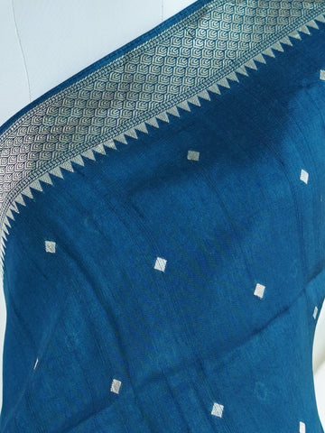 Georgette This Tussar Georgette saree from Varanasi brings together the textured richness of tussar silk with the fluid grace of georgette. Woven on a powerloom, it drapes light and airy, perfect for effortless elegance. Ideal for both day events and evening gatherings, it reflects quiet sophistication with a modern twist on tradition. Hemamalini - Georgette Saree | Handwoven | Varanasi - Manoranjitham Weaves - Handloom Store