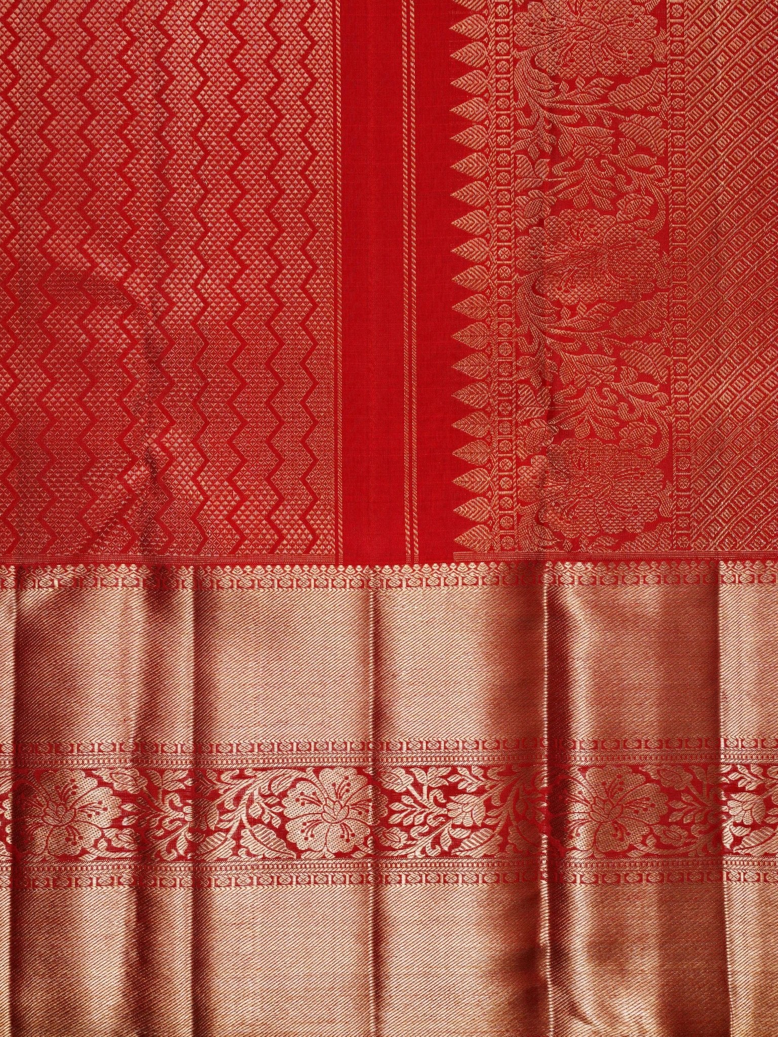 Kanchipuram Silk This 100% Pure Silk  silk saree, adorned in Red and detailed with Pure Zari weaving, reflects the grandeur of Maharashtra. The timeless Buttis motifs enhance its bridal charm. A perfect blend of luxury and tradition, it is designed for those who appreciate fine craftsmanship. Hemanta - Manoranjitham Weaves - Handloom Store