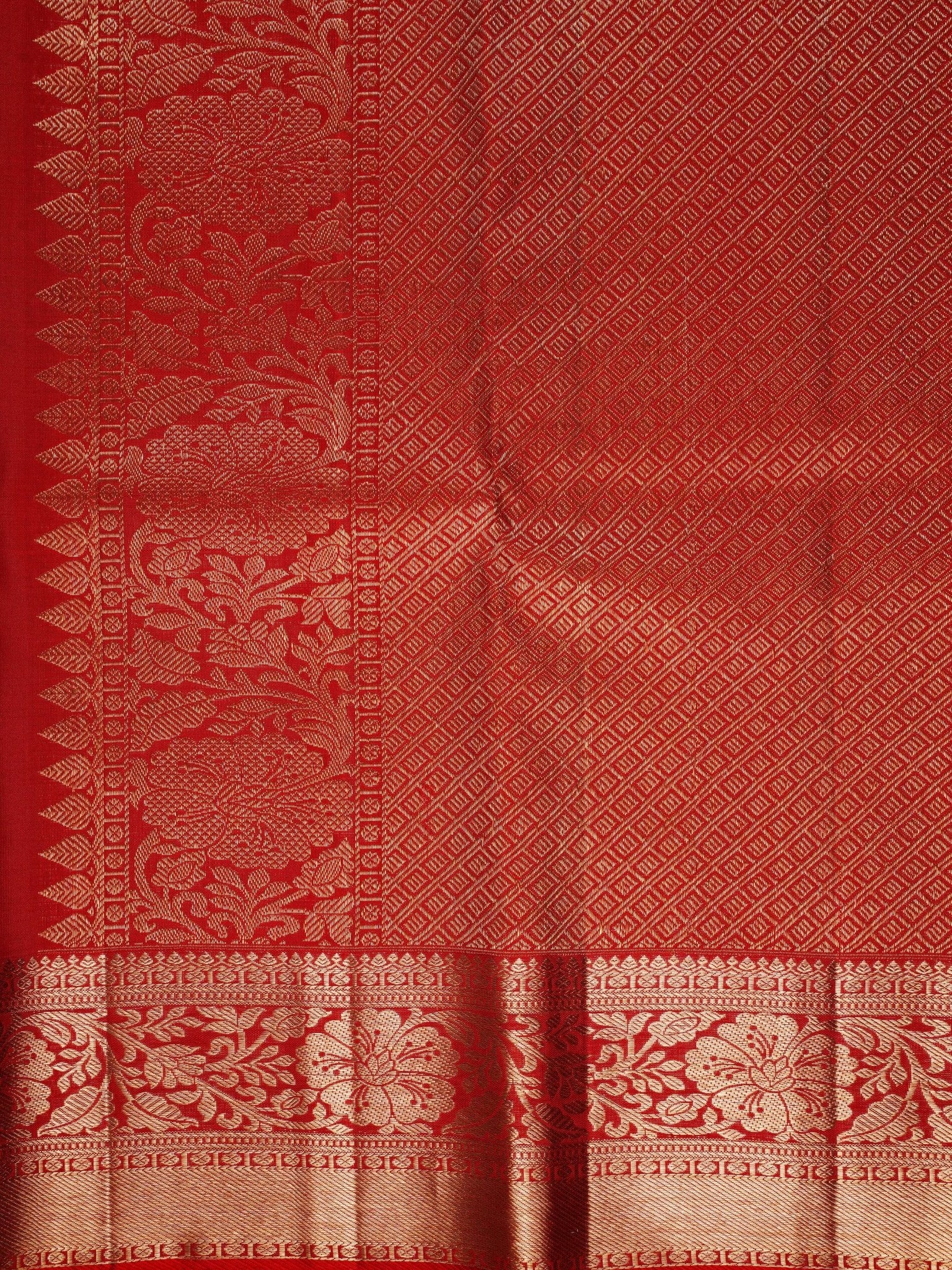Kanchipuram Silk This 100% Pure Silk  silk saree, adorned in Red and detailed with Pure Zari weaving, reflects the grandeur of Maharashtra. The timeless Buttis motifs enhance its bridal charm. A perfect blend of luxury and tradition, it is designed for those who appreciate fine craftsmanship. Hemanta - Manoranjitham Weaves - Handloom Store
