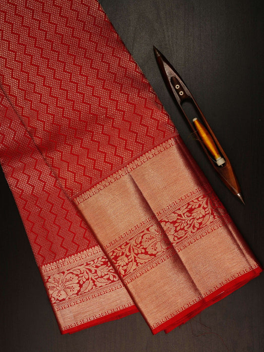 Kanchipuram Silk This 100% Pure Silk  silk saree, adorned in Red and detailed with Pure Zari weaving, reflects the grandeur of Maharashtra. The timeless Buttis motifs enhance its bridal charm. A perfect blend of luxury and tradition, it is designed for those who appreciate fine craftsmanship. Hemanta - Manoranjitham Weaves - Handloom Store