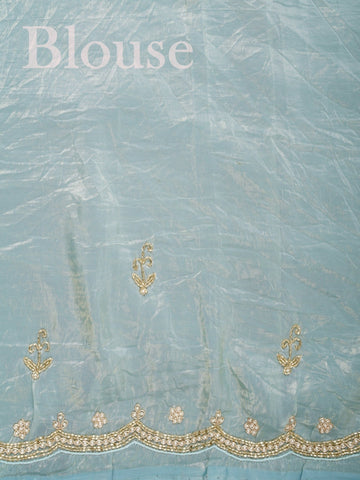 Organza Handwoven by skilled artisans of Karnataka, this 100% Pure Organza saree in Teal blends traditional elegance with intricate nan zari work. A truly stunning drape for special occasions. The interplay of colors and craftsmanship makes it a treasured piece for every saree connoisseur. Hindola - Teal Organza Saree - Manoranjitham Weaves - Handloom Store