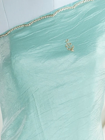 Organza Handwoven by skilled artisans of Karnataka, this 100% Pure Organza saree in Teal blends traditional elegance with intricate nan zari work. A truly stunning drape for special occasions. The interplay of colors and craftsmanship makes it a treasured piece for every saree connoisseur. Hindola - Teal Organza Saree - Manoranjitham Weaves - Handloom Store