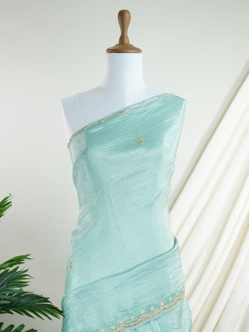 Organza Handwoven by skilled artisans of Karnataka, this 100% Pure Organza saree in Teal blends traditional elegance with intricate nan zari work. A truly stunning drape for special occasions. The interplay of colors and craftsmanship makes it a treasured piece for every saree connoisseur. Hindola - Teal Organza Saree - Manoranjitham Weaves - Handloom Store