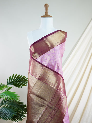 Kanchipuram Silk A masterpiece from Maharashtra, this 100% Pure Silk  saree in Baby Pink is a tribute to India's rich handloom legacy. The Pure Zari weaving and Buttis motifs make it a perfect choice for brides and celebrations. Every thread speaks of elegance, tradition, and the skilled hands that bring this saree to life. Jaunpuri - Pure Kanjivaram Silk Saree | Pure Zari - Manoranjitham Weaves - Handloom Store