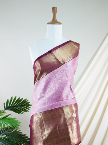 Kanchipuram Silk A masterpiece from Maharashtra, this 100% Pure Silk  saree in Baby Pink is a tribute to India's rich handloom legacy. The Pure Zari weaving and Buttis motifs make it a perfect choice for brides and celebrations. Every thread speaks of elegance, tradition, and the skilled hands that bring this saree to life. Jaunpuri - Pure Kanjivaram Silk Saree | Pure Zari - Manoranjitham Weaves - Handloom Store