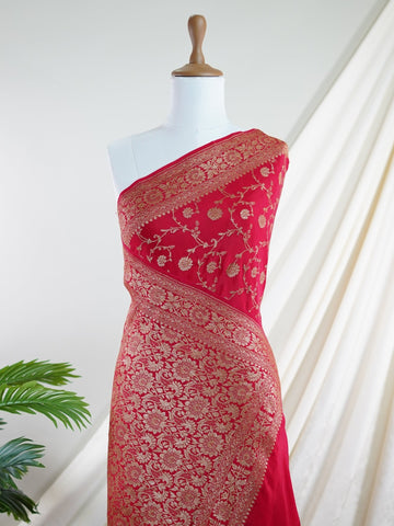 Crepe In bold red and radiant gold, this 100% pure crepe saree from Varanasi is adorned with delicate floral motifs. The soft drape and intricate weave bring together grace and grandeur in perfect harmony. A timeless piece for weddings, rituals, and every cherished celebration.br
#RedAndGoldSaree #VaranasiWeave #PureCrepeElegance #FloralHeritage #HandloomStories Jayantashree - Red Pure Banarasi Silk Saree | Woven Jaal - Manoranjitham Weaves - Handloom Store