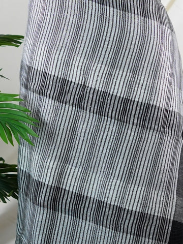 Linen A masterpiece from Rajasthan, this Linen saree in Black is a tribute to India's rich handloom legacy. The Semi Pure Zari weaving and Work motifs make it a perfect choice for brides and celebrations. Every thread speaks of elegance, tradition, and the skilled hands that bring this saree to life. Jogiya - Black Handloom Cotton Saree - Manoranjitham Weaves - Handloom Store