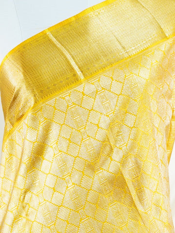 Kanchipuram Silk A masterpiece from Maharashtra, this 100% Pure Silk  saree in Golden Yellow is a tribute to India's rich handloom legacy. The Pure Zari weaving and Buttis motifs make it a perfect choice for brides and celebrations. Every thread speaks of elegance, tradition, and the skilled hands that bring this saree to life. Jogiya - Pure Kanjivaram Silk Saree - Manoranjitham Weaves - Handloom Store