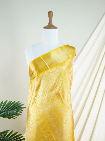 Kanchipuram Silk A masterpiece from Maharashtra, this 100% Pure Silk  saree in Golden Yellow is a tribute to India's rich handloom legacy. The Pure Zari weaving and Buttis motifs make it a perfect choice for brides and celebrations. Every thread speaks of elegance, tradition, and the skilled hands that bring this saree to life. Jogiya - Pure Kanjivaram Silk Saree - Manoranjitham Weaves - Handloom Store