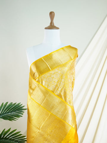 Kanchipuram Silk A masterpiece from Maharashtra, this 100% Pure Silk  saree in Golden Yellow is a tribute to India's rich handloom legacy. The Pure Zari weaving and Buttis motifs make it a perfect choice for brides and celebrations. Every thread speaks of elegance, tradition, and the skilled hands that bring this saree to life. Jogiya - Pure Kanjivaram Silk Saree - Manoranjitham Weaves - Handloom Store