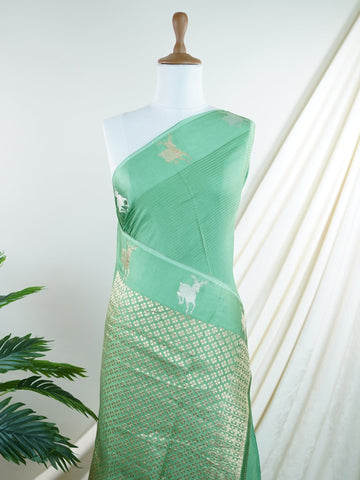 Mushru This Semi Mushru saree, woven on a powerloom in Varanasi, features elegant gold fine zari motifs that shimmer delicately across its fabric. The medium border adds a refined frame, enhancing its timeless appeal. It offers a perfect drape for festive and formal occasions, blending tradition with subtle luxury. Kalanemi - Semi Silk Saree - Manoranjitham Weaves - Handloom Store