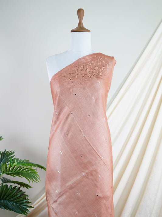 Tussars An orangish-peach Tussar saree that is extremely soft and flowing, featuring cutwork on the borders, pallu, and blouse, accented with lightweight mirror details for subtle sparkle. Kalyani - Manoranjitham Weaves - Handloom Store